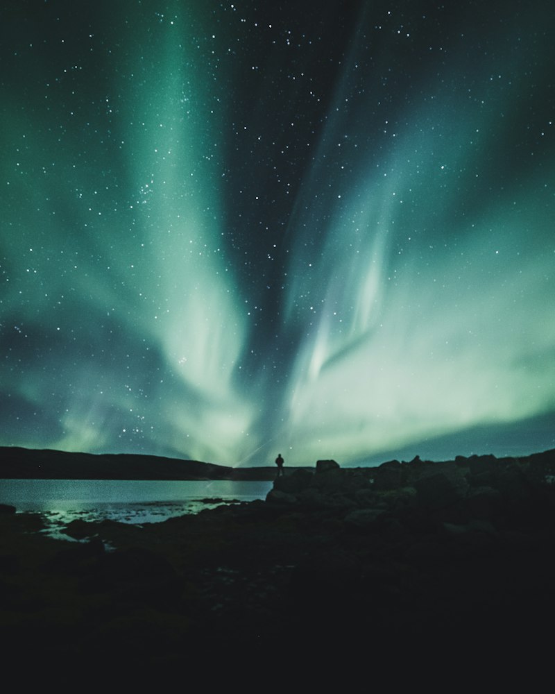 Nordic Winter Architecture: Glass Cabins and Aurora Borealis Under Dark Skies
