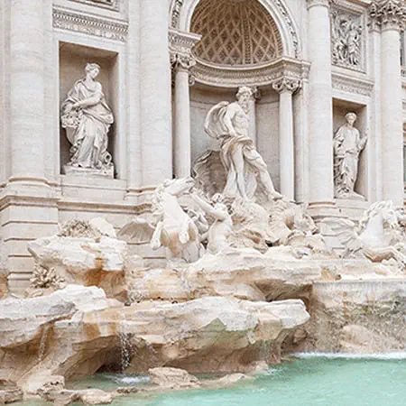 Baroque fountain with sculptural figures and cascading water in city plaza