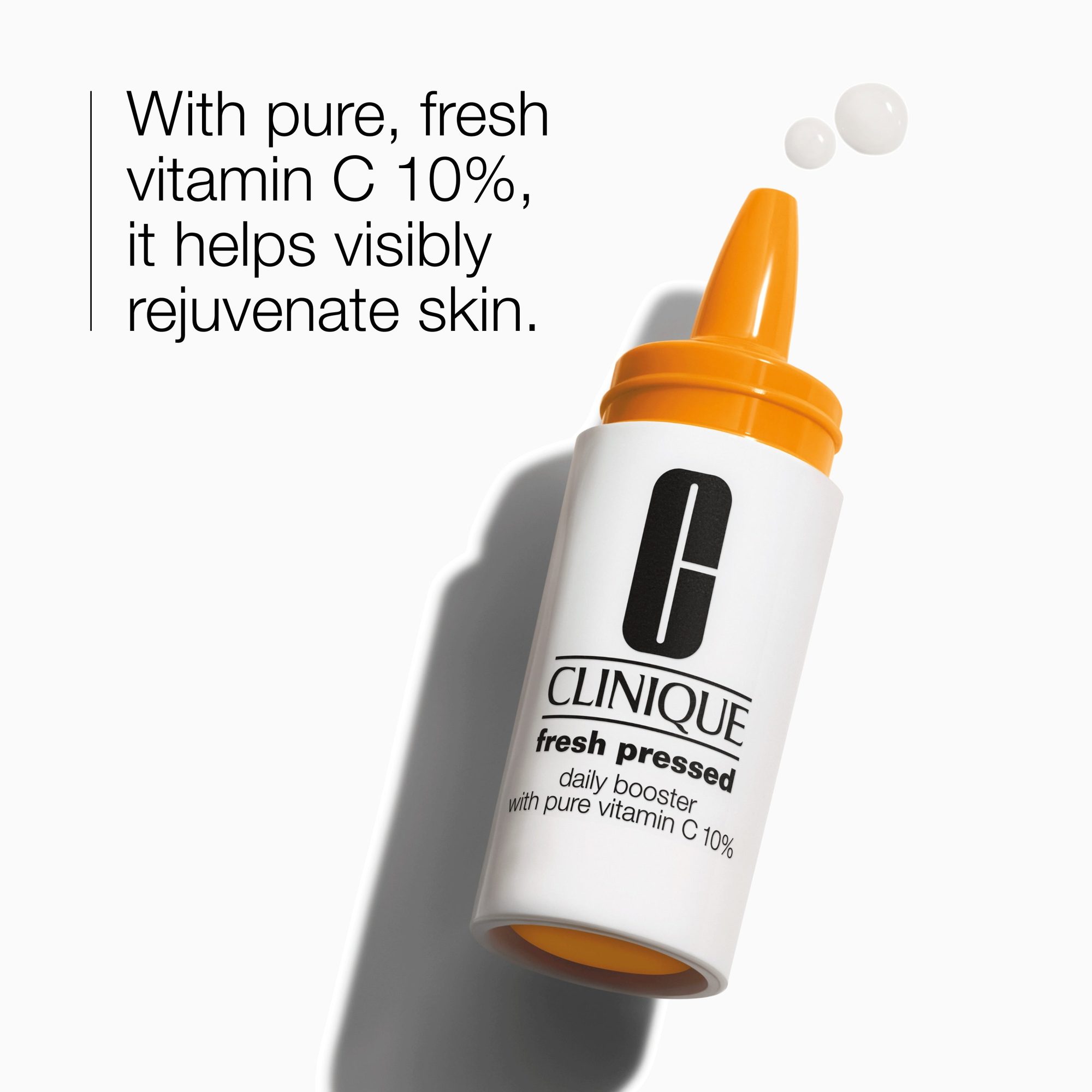 White bottle with orange pump top and dropper containing vitamin C serum with text describing skin rejuvenation benefits