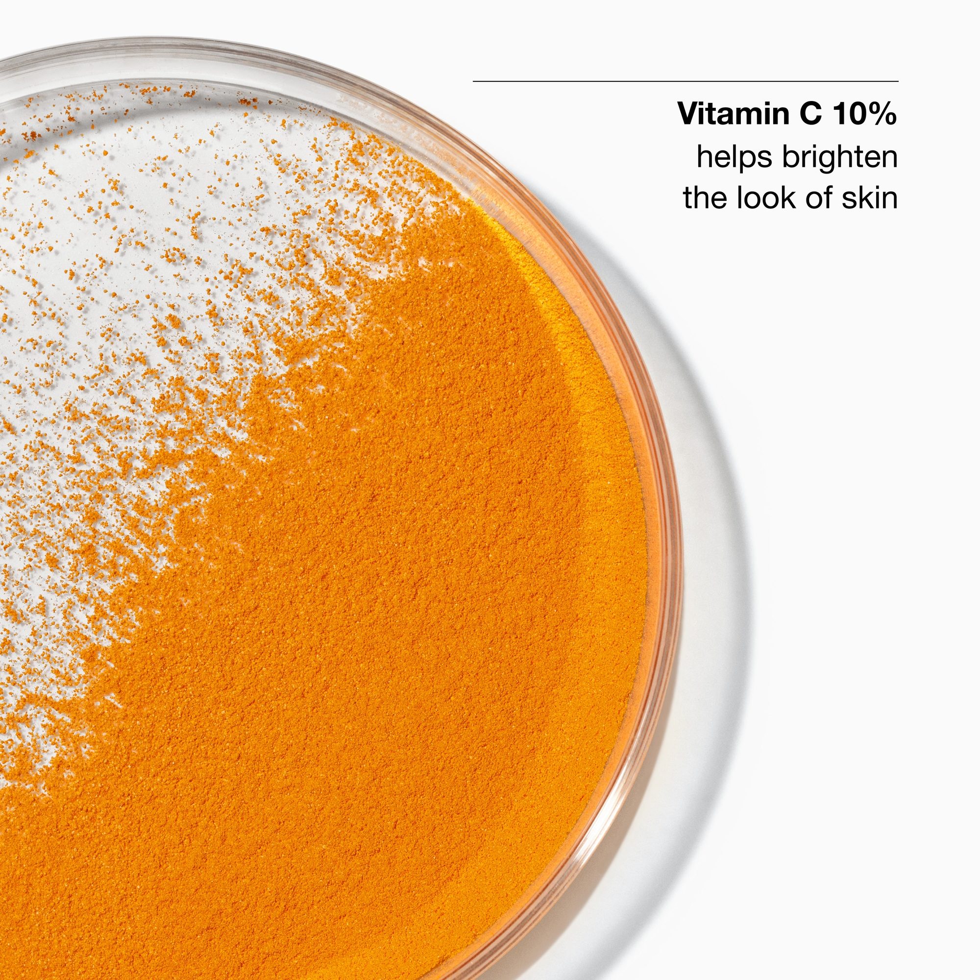 Close-up of orange and white powdered vitamin C concentrate in a clear circular container